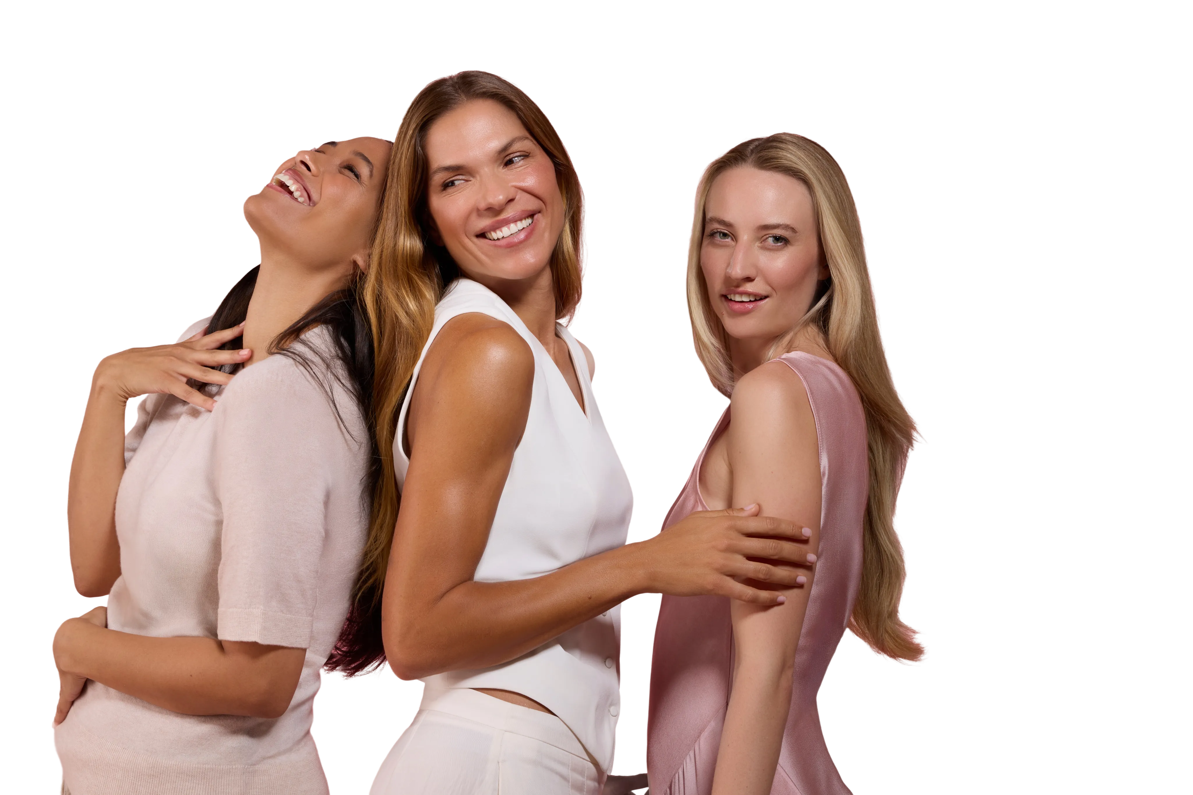 Three women smiling together, representing natural expression